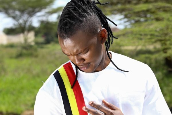 Man Touching Uganda National Colors on T-shirt with Respect